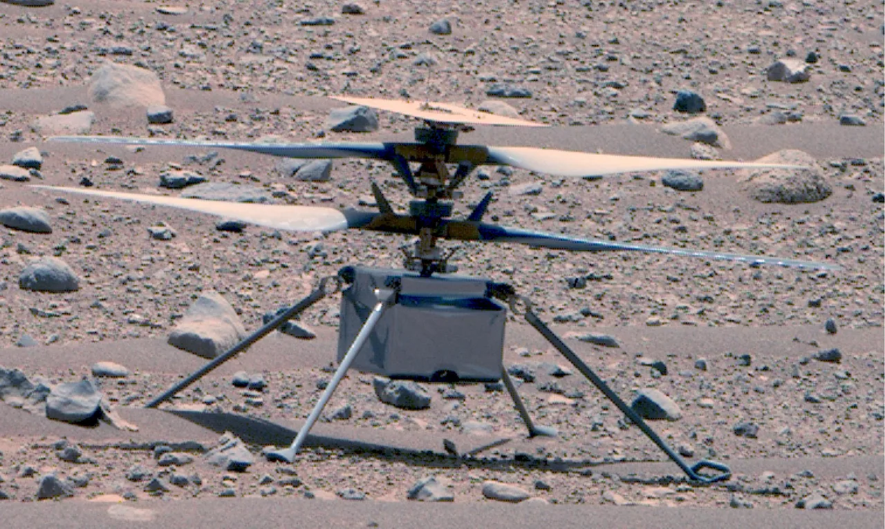 Ingenuity standing on the rocky surface of Mars, photographed by Perseverance in 2023.