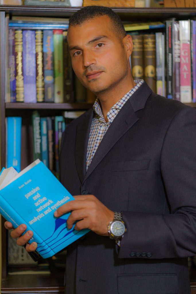 Loay Elbasyouni reading in his home office.